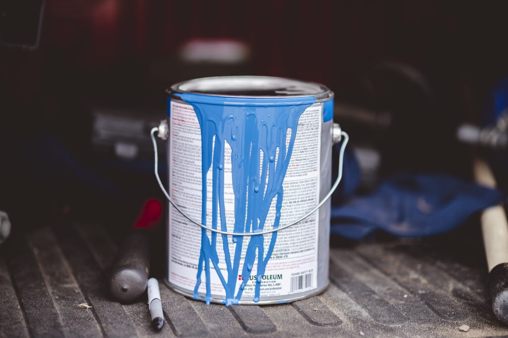 blue-paint-can-with-dripping-paint-in-truck-2026-03-18-09-44-19-utc