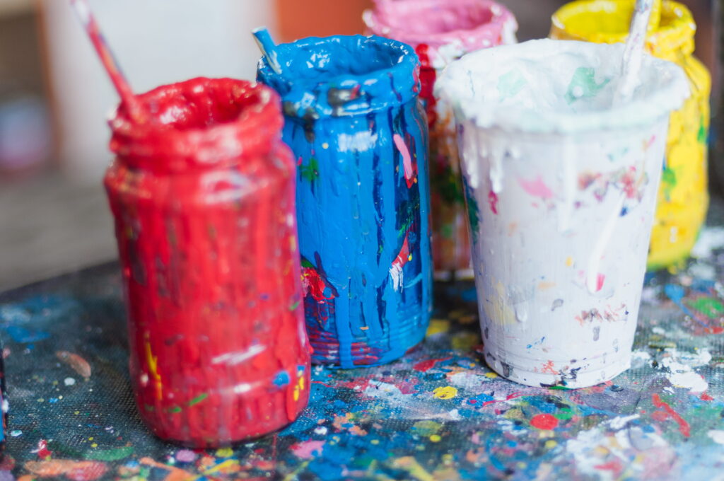 colorful-paint-containers-on-splattered-surface-2026-03-17-03-35-26-utc (1)