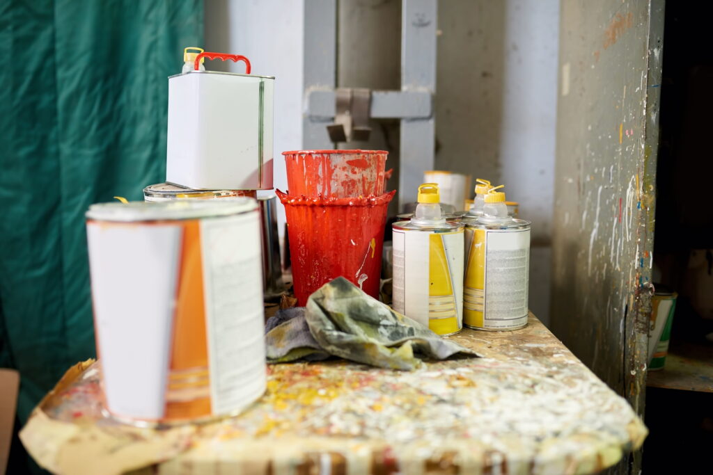 paint-cans-and-buckets-on-a-splattered-table-2026-03-09-04-34-34-utc (1)