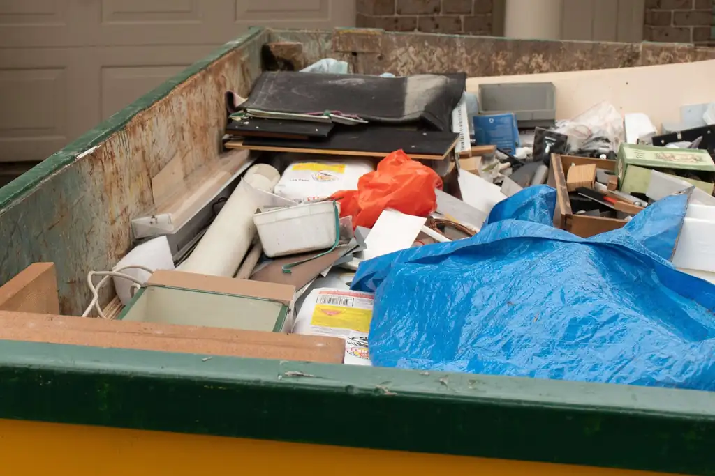 Bin full of household junk and renovation debris