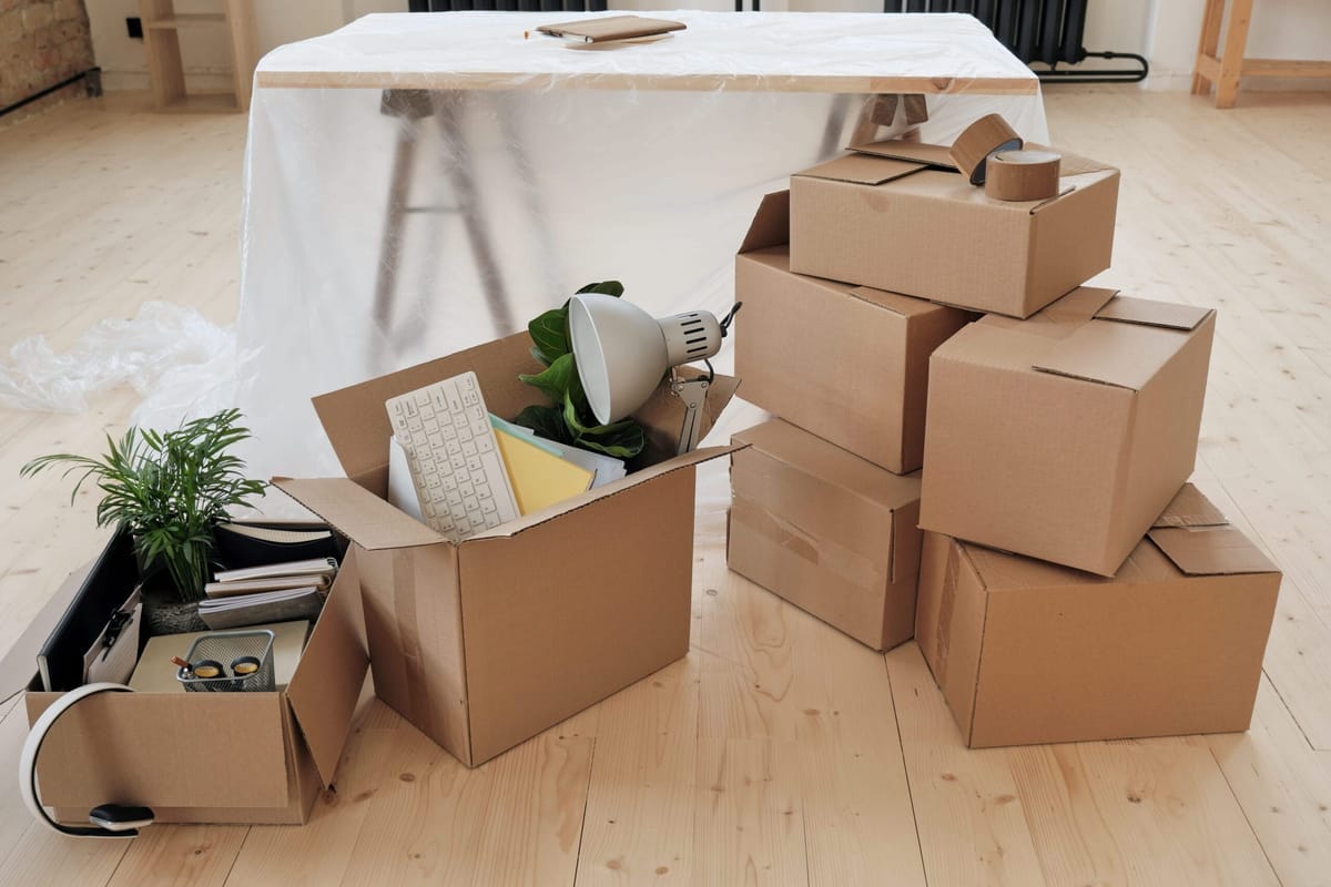 Labelled keep, family and donate boxes sorted in a Calgary living room during a downsizing move
